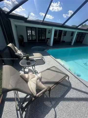 a backyard of a house with outdoor seating