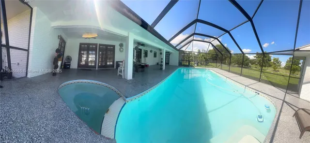 a view of a hallway with furniture and floor to ceiling window
