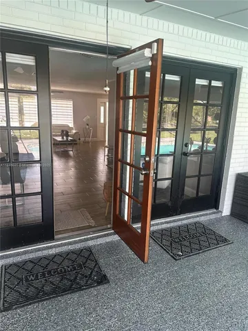 a view of a kitchen with refrigerator and windows