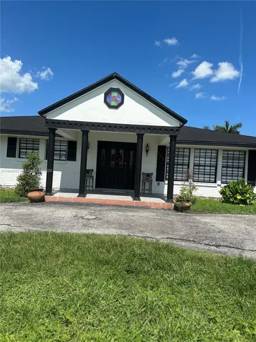 a large white house with a yard