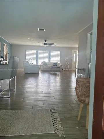 a large kitchen with a large window and stainless steel appliances