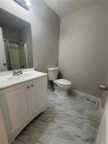 a bathroom with a sink toilet and mirror