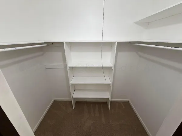 a bathroom with a granite countertop toilet sink and mirror