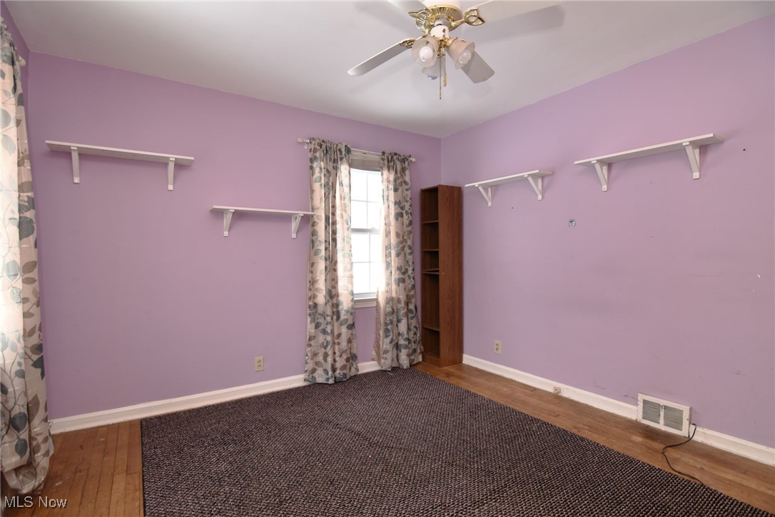 6308 Highland Road Cleveland, OH 44143 - Photo 24 of 40 Empty room with baseboards, visible vents, a ceiling fan, and wood finished floors
