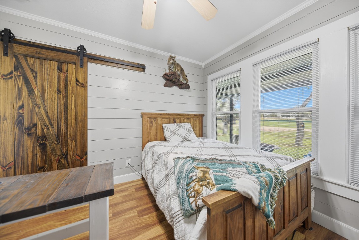 407 North Summit Street Weimar, TX 78962 - Photo 11 of 24 a bed sitting in a bedroom next to a window