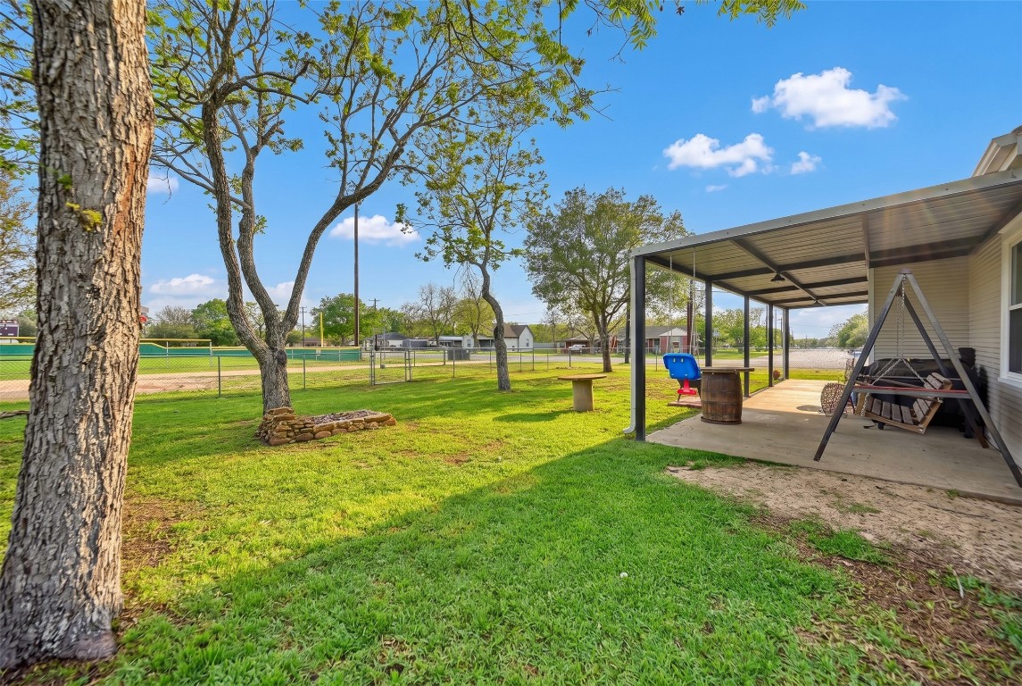 407 North Summit Street Weimar, TX 78962 - Photo 20 of 24 a view of a park with swings and a table