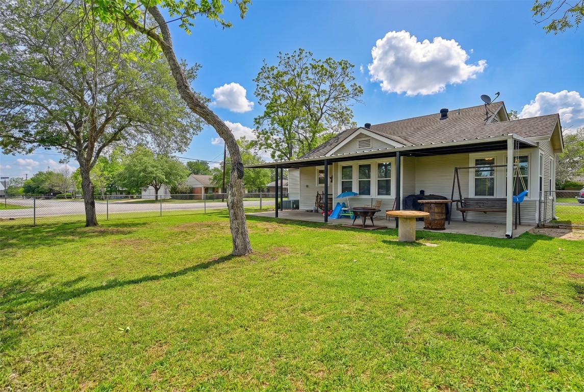 407 North Summit Street Weimar, TX 78962 - Photo 23 of 24 a backyard of a house with table and chairs