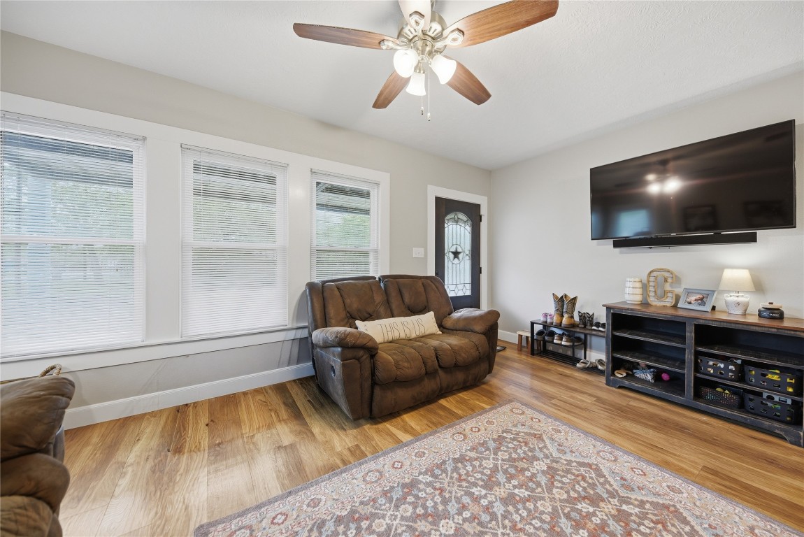 407 North Summit Street Weimar, TX 78962 - Photo 3 of 24 a living room with furniture and a flat screen tv