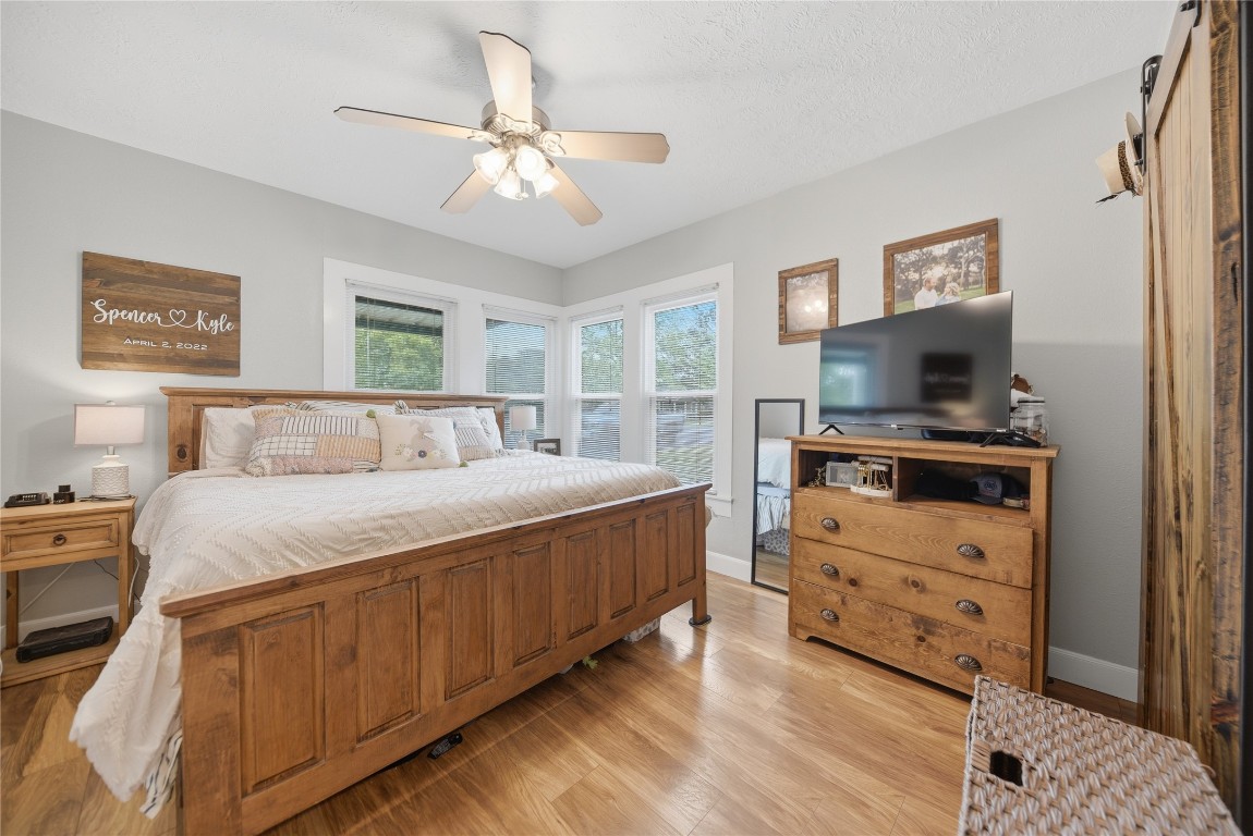407 North Summit Street Weimar, TX 78962 - Photo 9 of 24 a bedroom with a bed and a flat screen tv