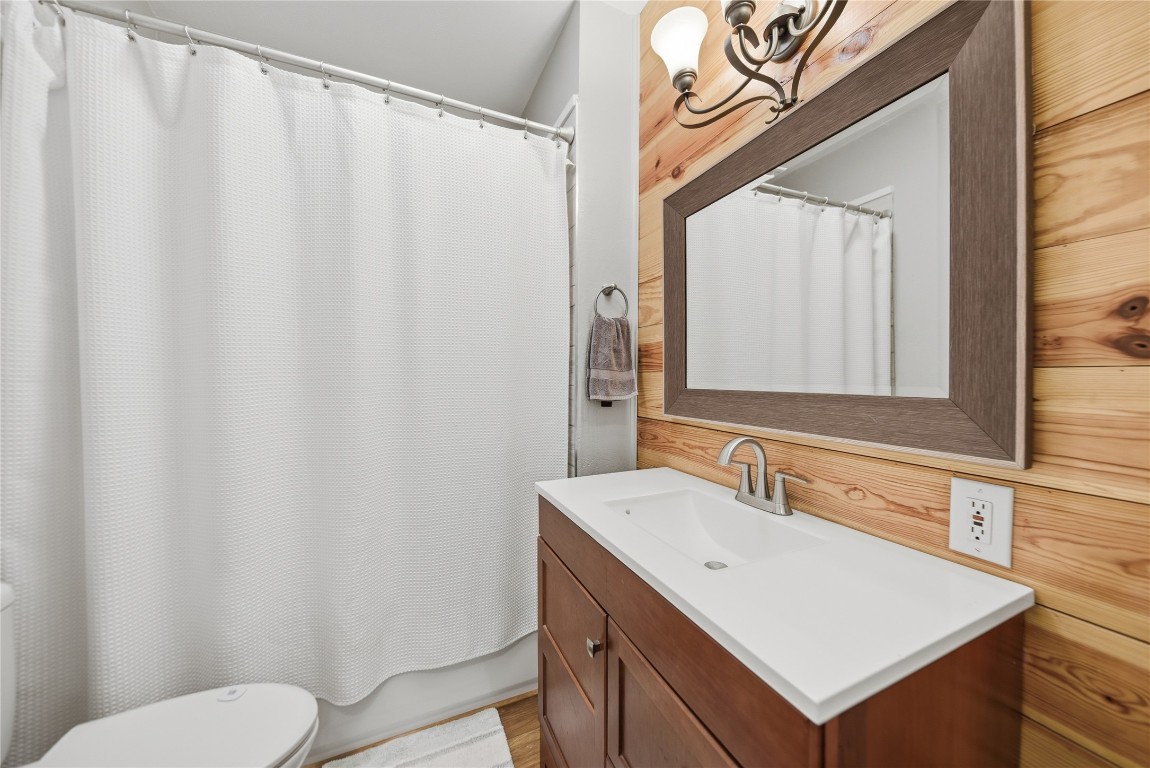 407 North Summit Street Weimar, TX 78962 - Photo 10 of 24 a bathroom with a sink a toilet and a mirror