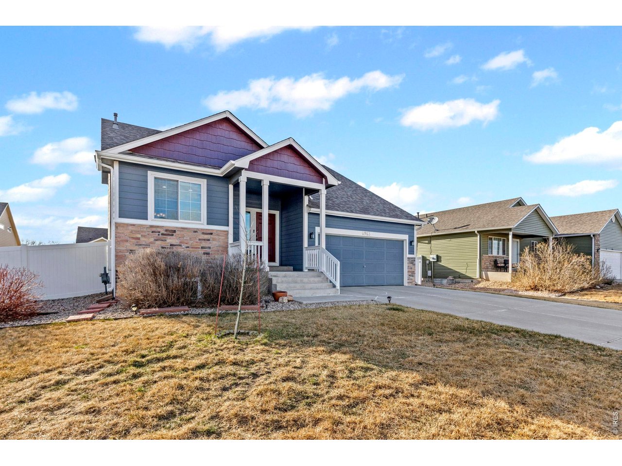 6963 Lee Street Wellington, CO 80549 - Photo 2 of 24 Charming curb appeal with a welcoming front porch, attached 2-car garage, and spacious driveway.