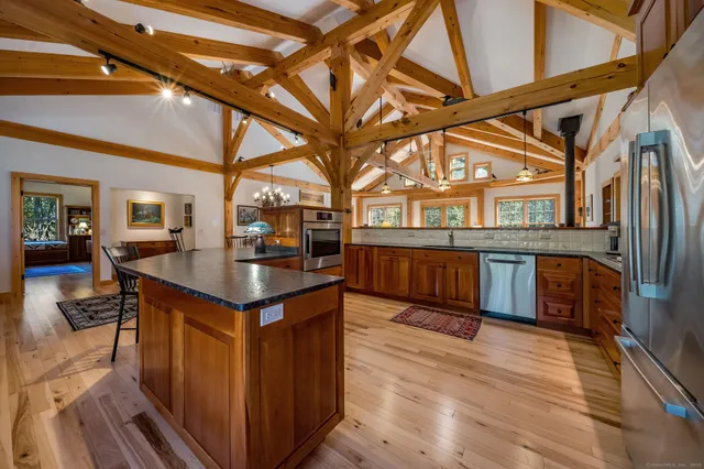 a kitchen with stainless steel appliances granite countertop a stove and cabinets