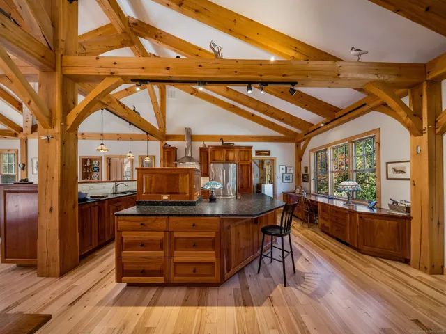 a dining room with a wooden table and chairs