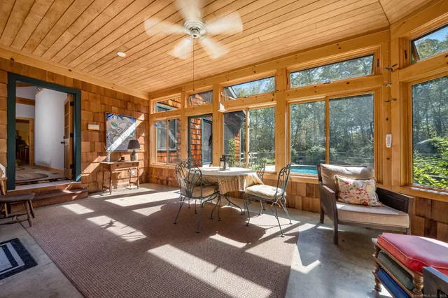 a living room with lots of furniture and a large window