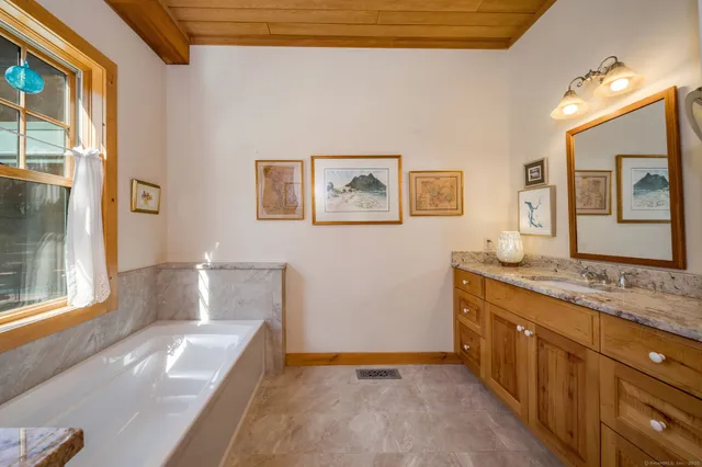 a spacious bathroom with a granite countertop sink mirror and a
