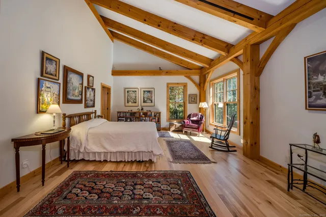 a bed room with a bed and wooden floor