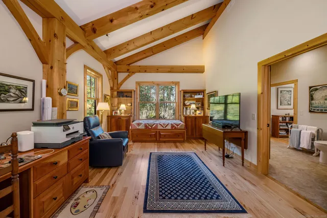 a living room with furniture a rug and a large window