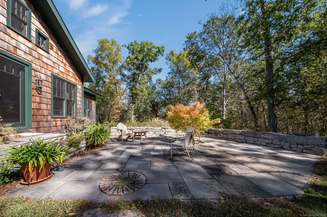 a backyard of a house with outdoor seating