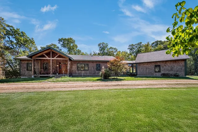 a front view of house with yard and green space