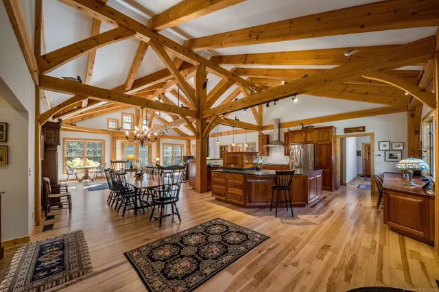 a view of a dining room with furniture wooden floor and chandelier