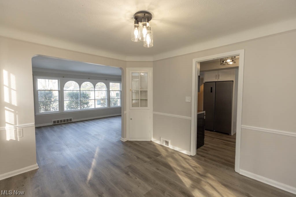 3890 Wallingford Road South Euclid, OH 44121 - Photo 4 of 19 Spare room featuring an inviting chandelier and dark hardwood / wood-style floors