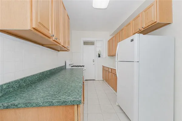 a view of a kitchen cabinets and a stove