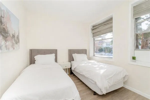 a bedroom with two beds and a window