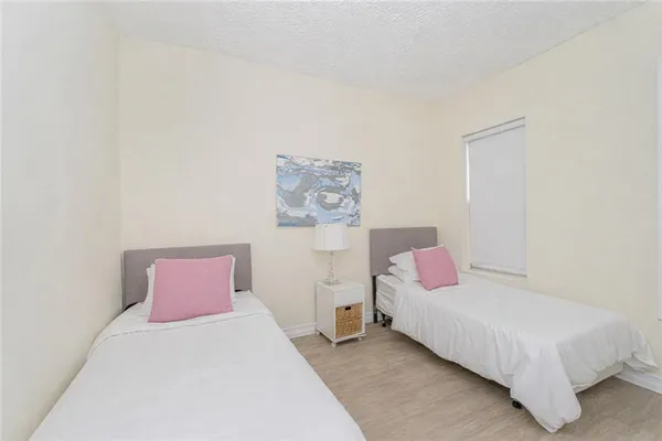 a bedroom with a bed and painting on the wall