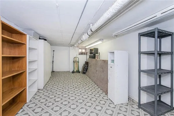 a view of a hallway with closet and racks