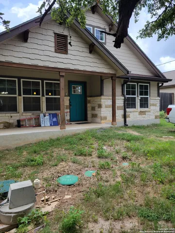 a front view of a house with a yard and chairs