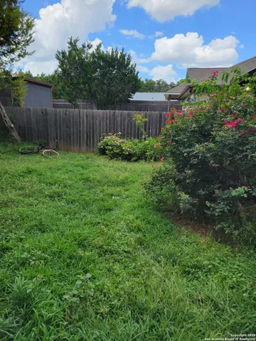 a view of backyard with garden and deck