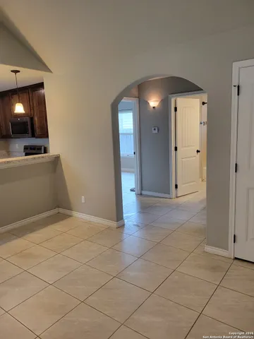 an empty room with a fireplace and wooden floor