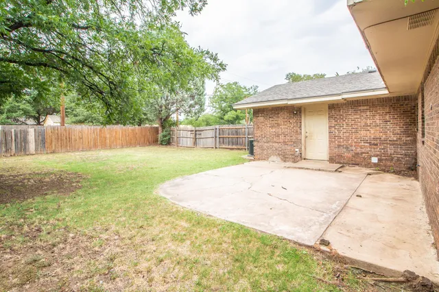 a view of a backyard of the house