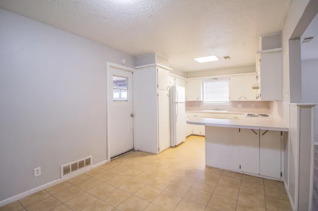 a view of kitchen with granite countertop cabinets and sink