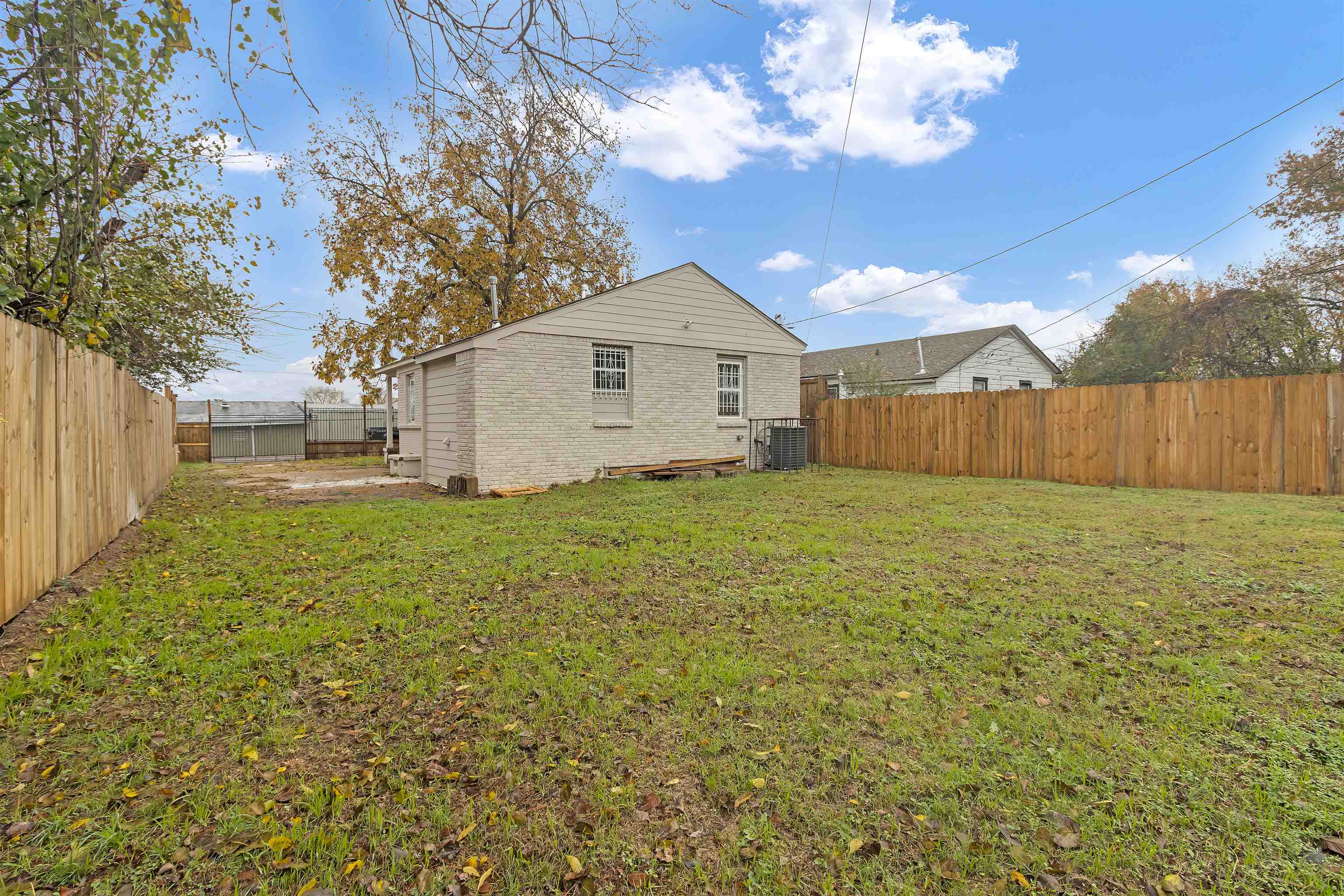 2881 Tutwiler Avenue Memphis, TN 38112 - Photo 21 of 23 Rear view of property with a fenced backyard and brick siding
