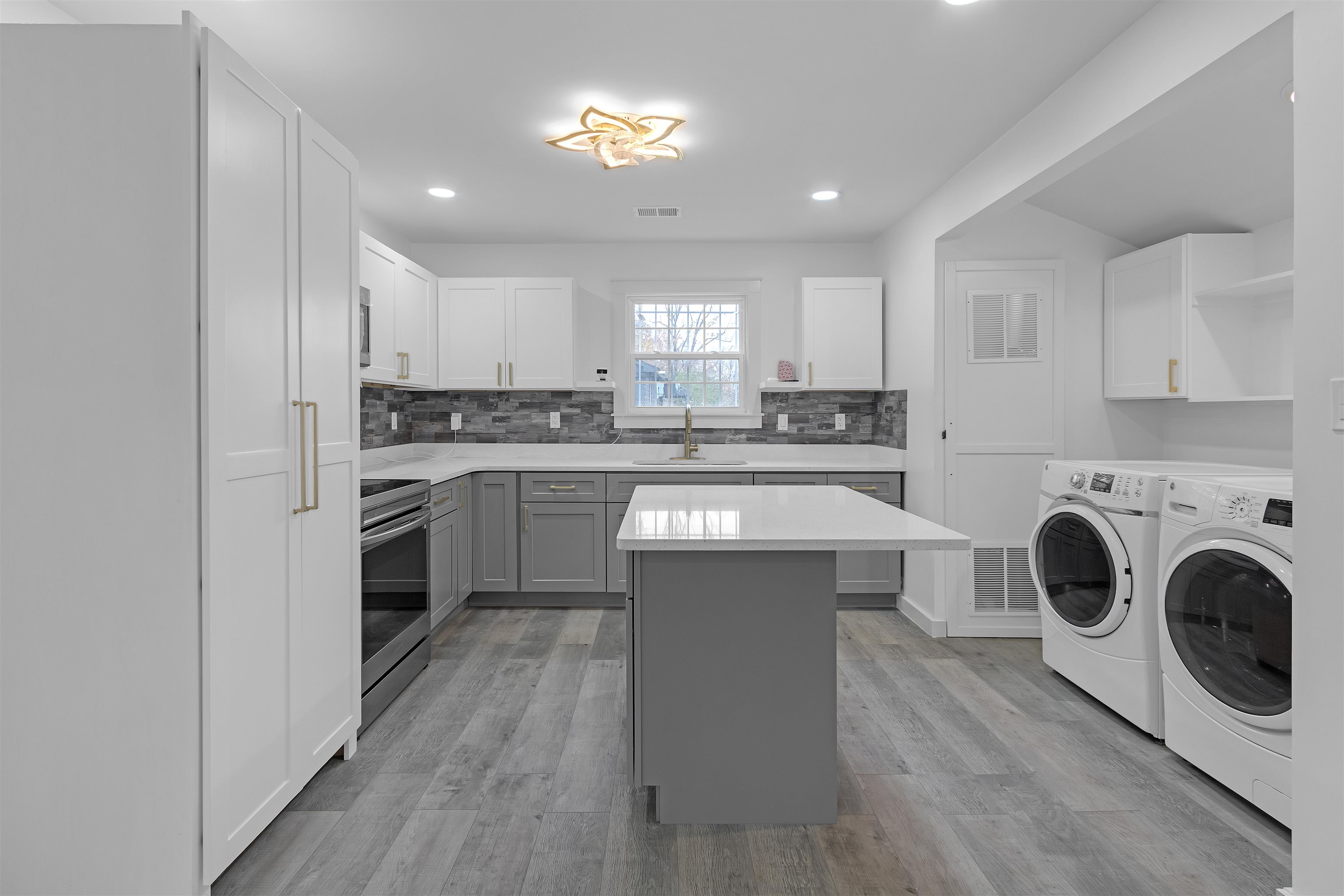 2881 Tutwiler Avenue Memphis, TN 38112 - Photo 7 of 23 Kitchen with gray cabinetry, decorative backsplash, stainless steel range with electric stovetop, light wood-type flooring, and recessed lighting
