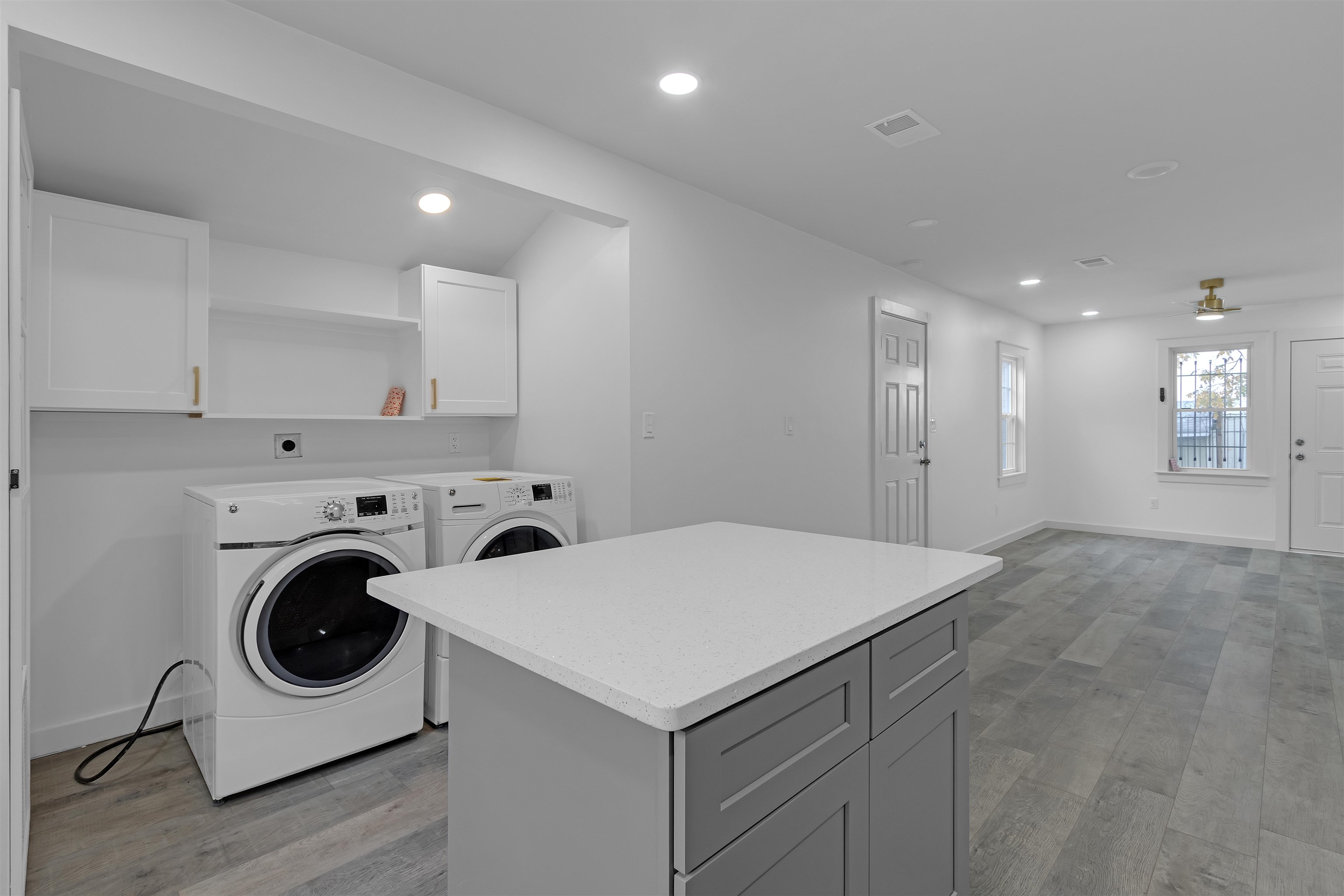 2881 Tutwiler Avenue Memphis, TN 38112 - Photo 10 of 23 Laundry room with recessed lighting, light wood finished floors, ceiling fan, cabinet space, and separate washer and dryer