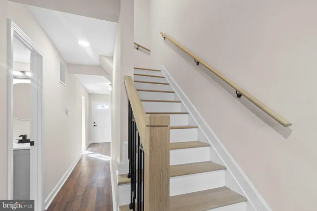 a view of entryway and gallery with wooden floor