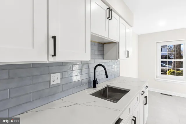a kitchen with granite countertop a sink and a microwave