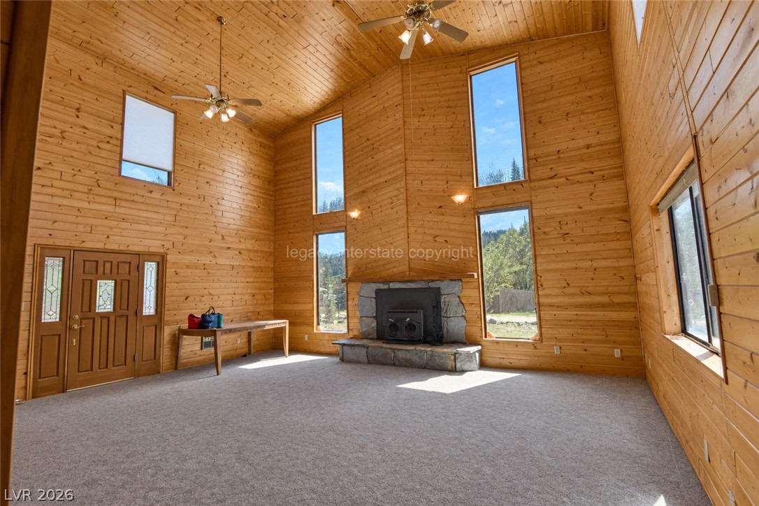 1129 East Ponderosa Road Hatch, UT 84735 - Photo 4 of 47 Wood-paneled walls and a stone fireplace anchor this soaring living space with abundant windows.