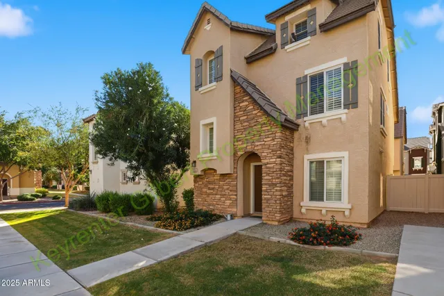 a view of a house with a yard and sitting area