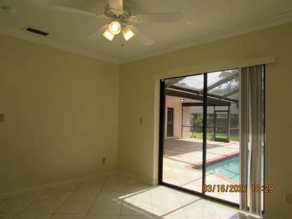 a view of an empty room with glass door