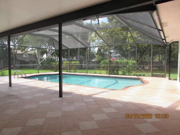 a view of a backyard with a swimming pool