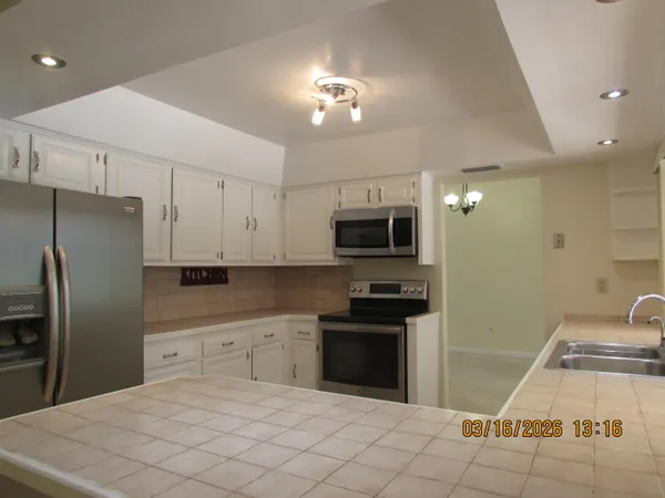 a kitchen with stainless steel appliances a stove a refrigerator sink and cabinets