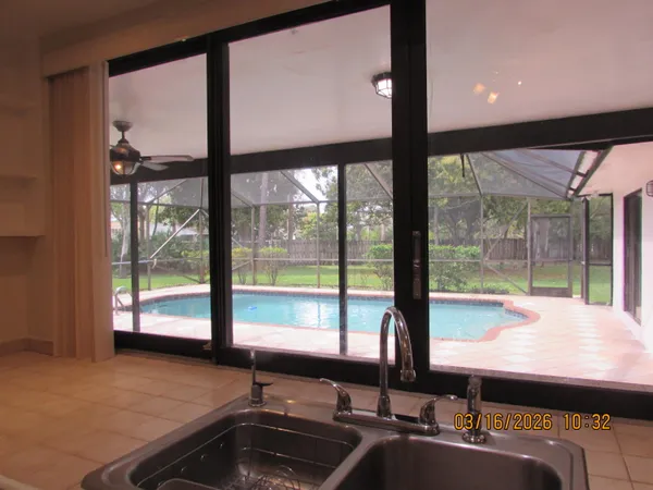 a room with pool table and windows