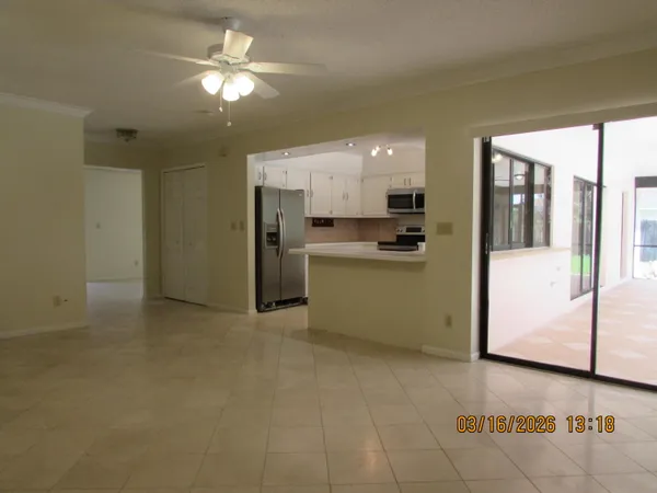 a view of a kitchen with a sink a refrigerator and window