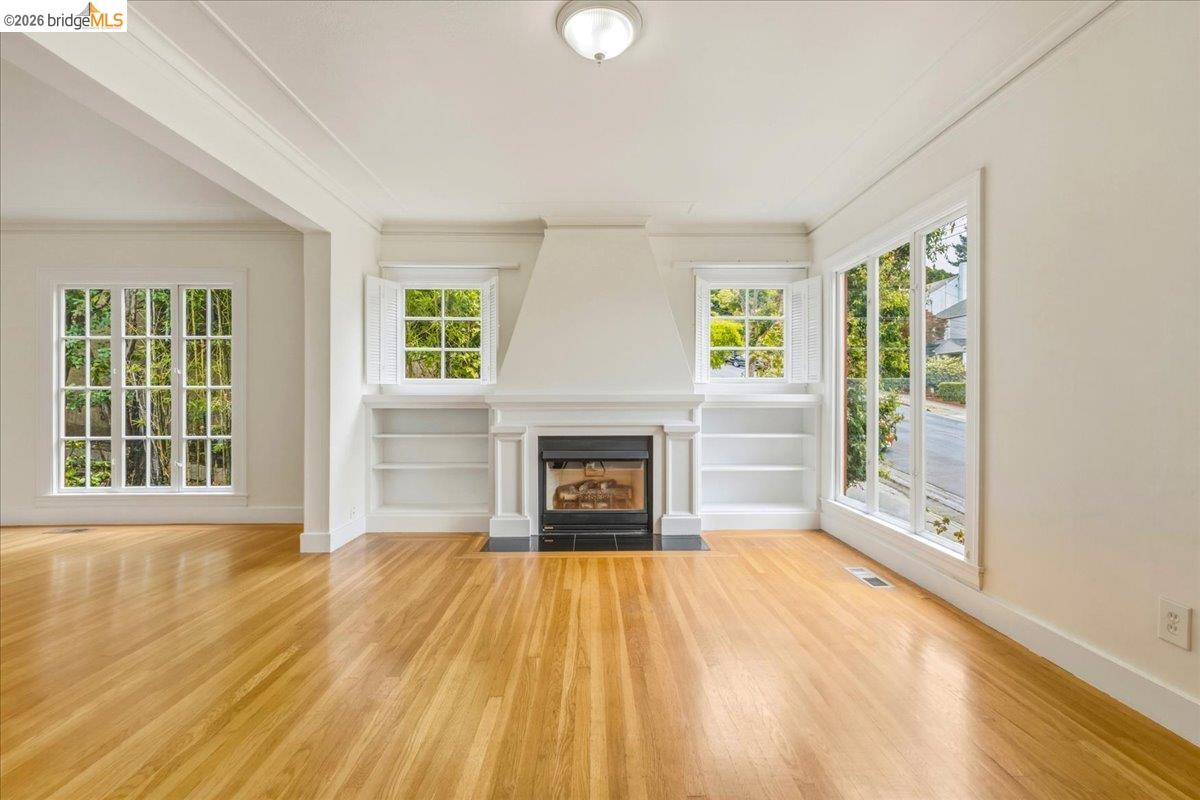 2403 Cedar Street Berkeley, CA 94708 - Photo 21 of 33 Living area featuring a central fireplace with a black surround and white mantel