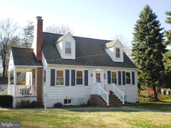 2115 Stonewall Road Catonsville, MD 21228 - Photo 1 of 19 a front view of a house with a yard and swimming pool