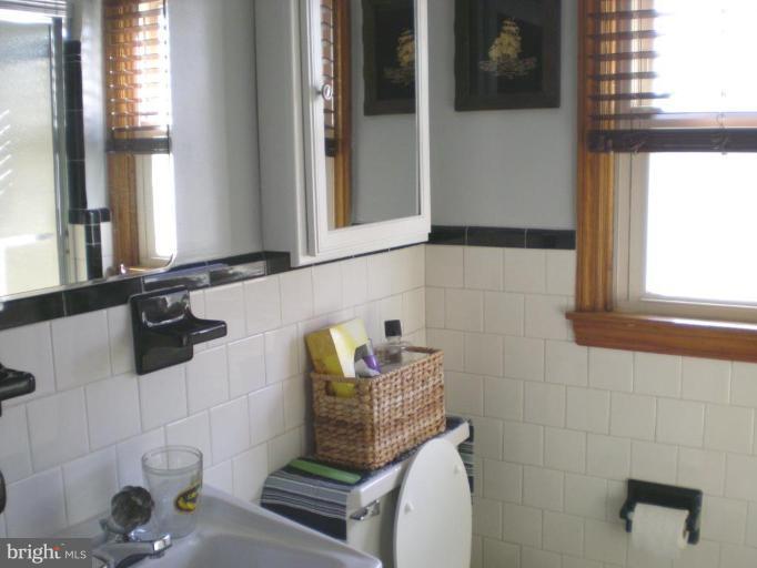 2115 Stonewall Road Catonsville, MD 21228 - Photo 14 of 19 a bathroom with a sink and a mirror