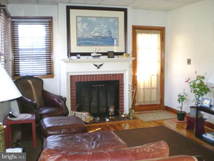 2115 Stonewall Road Catonsville, MD 21228 - Photo 7 of 19 a living room with furniture and a fireplace